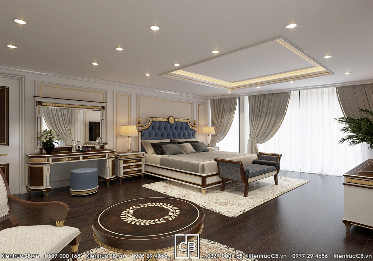 Phòng ngủ với giường lớn, đầu giường màu xanh và bàn trang điểm